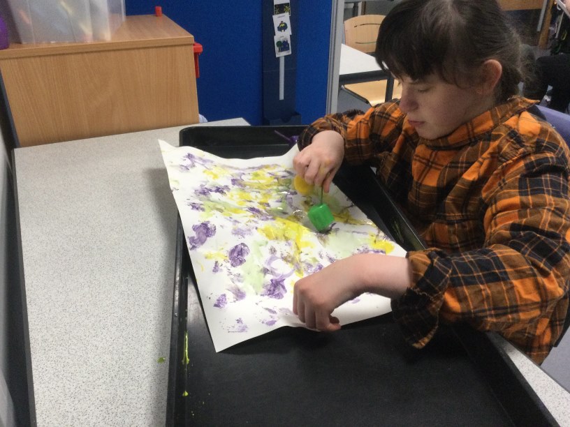 Kayla intent on her painting.JPG